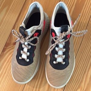 Stylish Tan and Black Sneakers with Red Accents